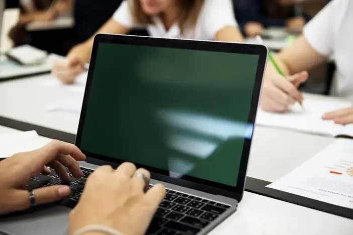 College student taking notes during class