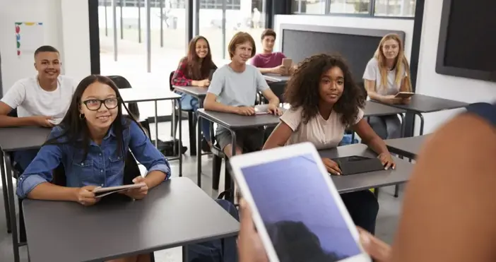 Teacher uses tablet to view lesson plan